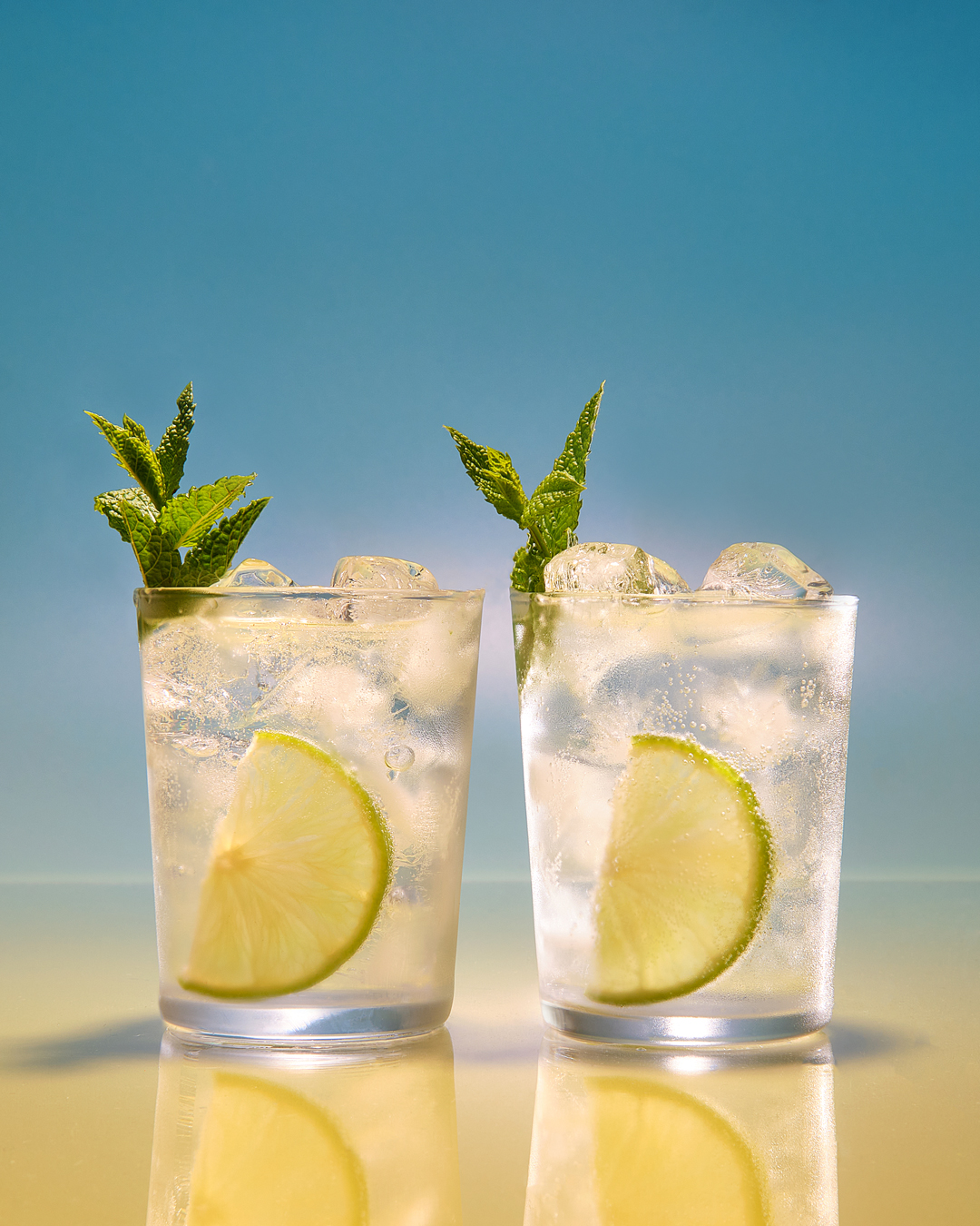 two glasses of mojito with slice of lime and mint garnish